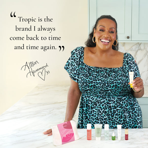 Alison Hammond smiles while holding Tropic SPF 50 sunscreen beside a quote about Tropic, with Alison’s Edit displayed on the worktop below.