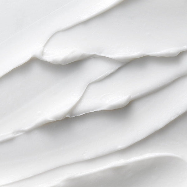 Smooth white creamy texture of Tropic Look Sharp Sensitive Shave, showcasing its rich, velvety consistency that cushions and hydrates the skin during shaving.