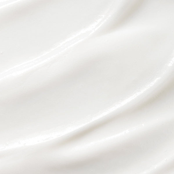 Close-up of a smooth, creamy white texture with gentle swirls, showcasing the rich and nourishing consistency of Tropic’s hair or skincare formulation.