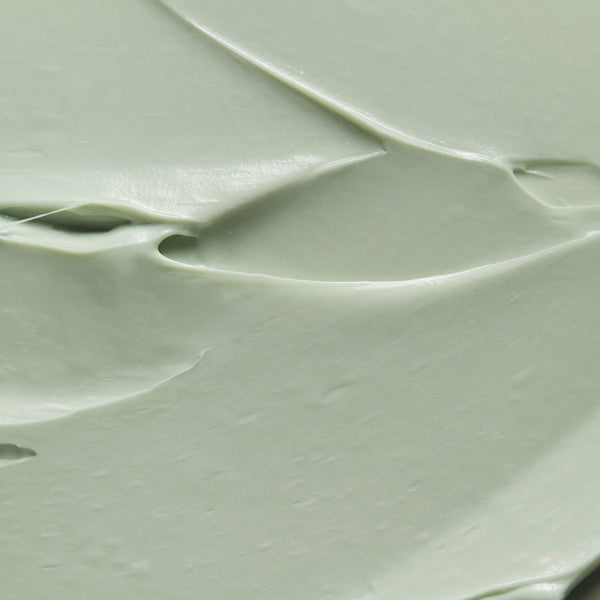 Close-up texture of Tropic Tamanu Cream showing a smooth, light green buttery surface that reflects its rich, soothing formulation for sensitive skin.