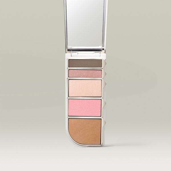 Tropic Colour Palette in the “Spring” shade, featuring five pressed powders in nude, pink, and brown tones arranged vertically with a built-in mirror.