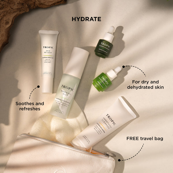 Tropic Hydrate skincare set including Skin Re-Leaf, Morning Mist, Super Greens, Rainforest Dew, and Smoothing Cleanser, displayed with a free travel bag. Text highlights benefits: 'Soothes and refreshes,' 'For dry and dehydrated skin,' and 'FREE travel bag'.