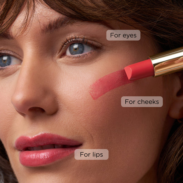 Close-up of a model with Butter Tint applied to lips and swatched on cheek, highlighting use for eyes, cheeks, and lips.