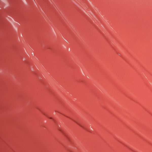 A glossy coral-toned texture with smooth, creamy swirls.