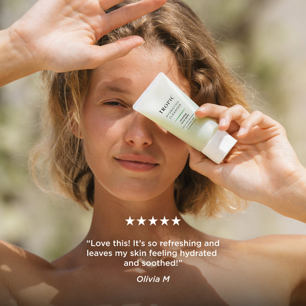 Person holding Tropic Hydrating Cleanser beside their face with five-star customer review: 