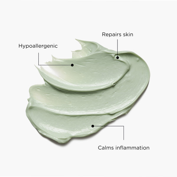 Smooth, light green swatch of Tropic Tamanu Cream shown on a white background with labels highlighting its benefits: hypoallergenic, repairs skin, and calms inflammation.