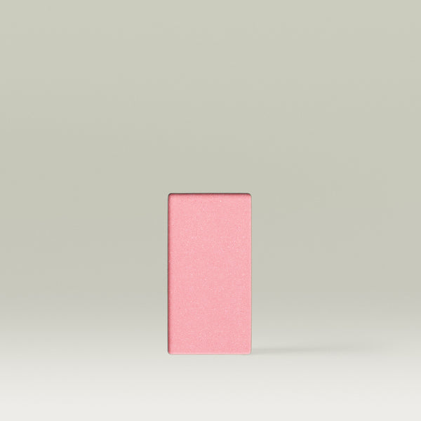 Single Tropic Blush Crush refill in the shade Rosy Glow, shown as a rectangular soft pink pan with a satin finish against a neutral background.