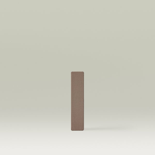 Rectangular makeup brow powder pan in a cool-toned medium brown shade, standing vertically against a soft neutral background. In shade Walnut.