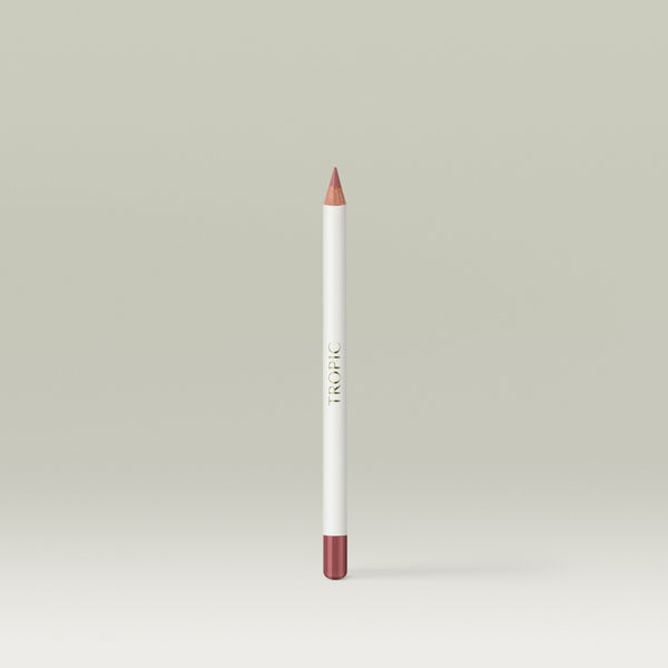 A white lip pencil with a sharpened rosy-pink tip and matching coloured end cap, labelled “Tropic” along the side. Shade: Flirt.