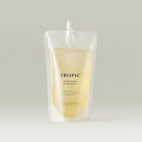 Tropic Signature Hand Wash refill pouch containing golden liquid soap, designed for eco-friendly replenishment with Australian lemon myrtle, bergamot, and eucalyptus essential oils.