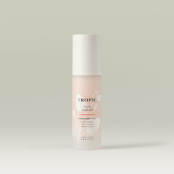 Tropic Skin Dream firming night cream with plant ceramides, bio-retinol, and murumuru butter, certified organic. In a frosted pink bottle with white cap, featuring minimalist floral design.