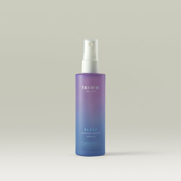 Tropic Pillow Mist in a ambre purple blue bottle, containing lavender, chamomile, and frankincense essential oils to promote relaxation and restful sleep.