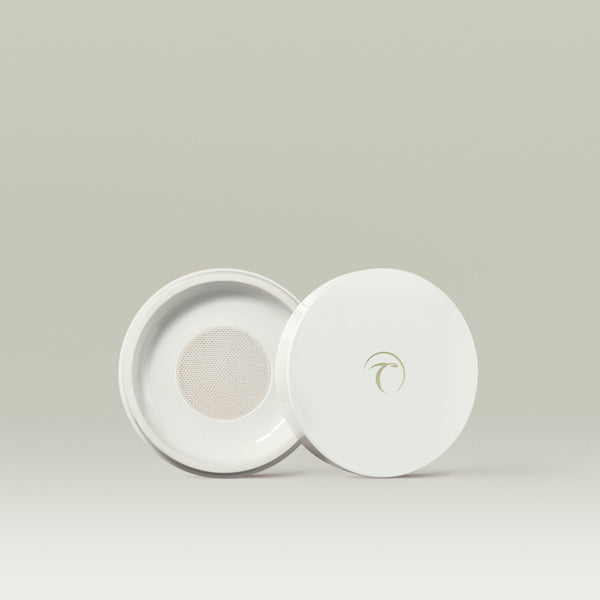 White round Tropic compact with the lid slid open to reveal a fine mesh sifter inside, designed for holding Soft Focus powder.