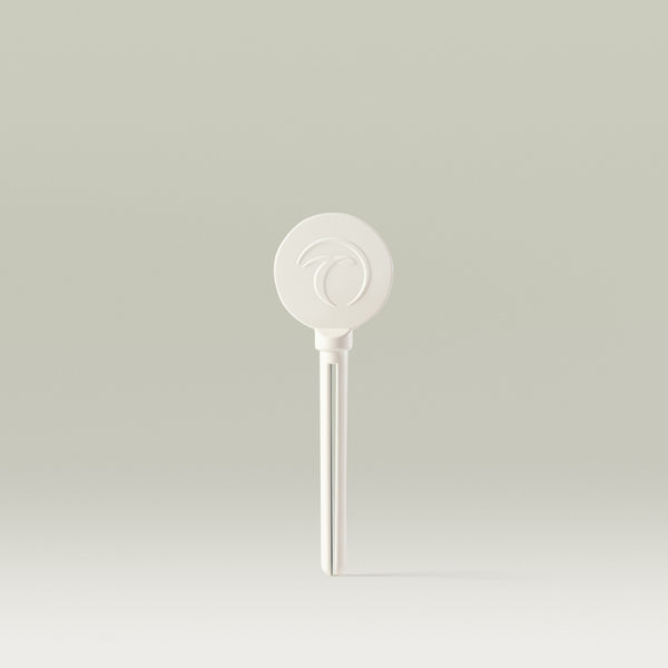 Minimalist image of a white Tropic Waste Not Wand, featuring the Tropic logo embossed on the round top and a sleek, simple design against a neutral background.