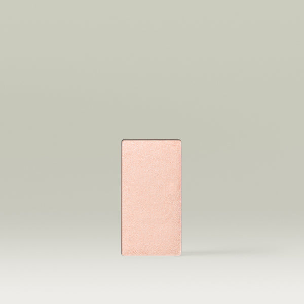 Rectangular Tropic “Way To Glow” highlighter pan in the shade Spring Lily, shown as a single refill in a soft peachy-champagne tone.