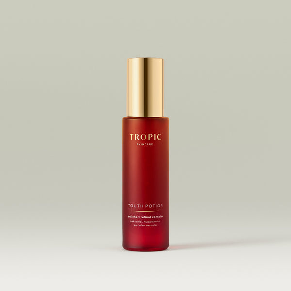 Tropic Youth Potion serum bottle with a gold pump on a neutral background.