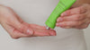 Model squeezes the tube to dispense the mask into their hands. They then apply the mask to their face with their hands. They leave it on their skin for the specified time and then remove with a damp bamboo cloth.