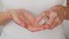 Model pumps Skin Dream moisturiser into their hands. Revealing the thick pink cream texture. They then apply to their face and neck.