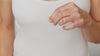 Model holds the hydrogel eye mask in their hands applying them gently just underneath both their eyes.